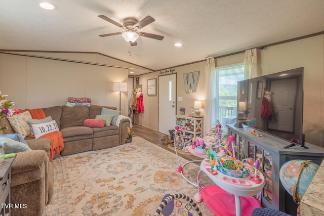 living room featuring ceiling fan, vaulted ceiling, recessed lighting, and a textured ceiling