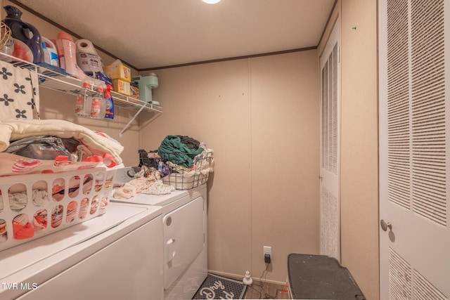 laundry area featuring a heating unit, washer and clothes dryer, and crown molding