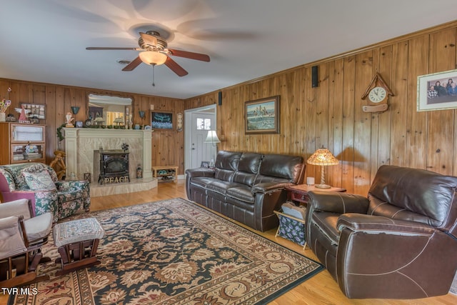 629 Buffalo Rd, Blountville, TN 37617 - living area featuring ceiling fan, wooden walls, wood finished floors, and a high end fireplace