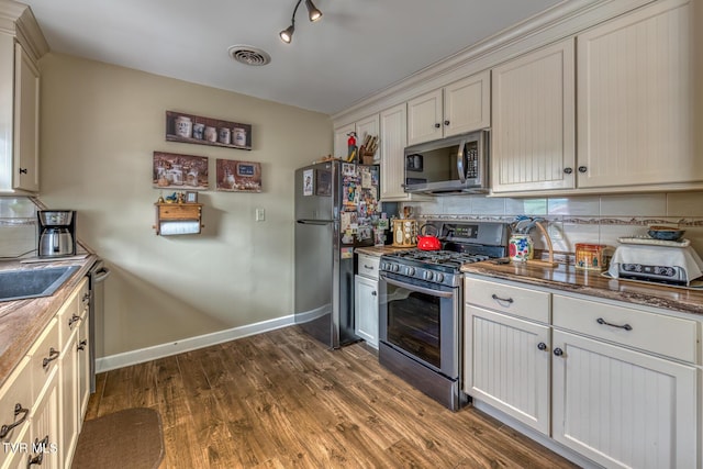 629 Buffalo Rd, Blountville, TN 37617 - kitchen featuring appliances with stainless steel finishes, backsplash, dark wood-style floors, and baseboards