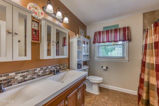 629 Buffalo Rd, Blountville, TN 37617 - full bath featuring decorative backsplash, tile patterned floors, double vanity, toilet, and baseboards