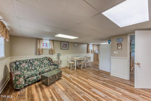 629 Buffalo Rd, Blountville, TN 37617 - living area with wood finished floors, a drop ceiling, and a wainscoted wall