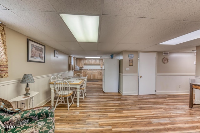 629 Buffalo Rd, Blountville, TN 37617 - dining area featuring a paneled ceiling, light wood finished floors, and a wainscoted wall