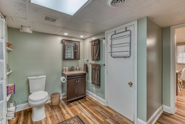 629 Buffalo Rd, Blountville, TN 37617 - bathroom featuring a drop ceiling, wood finished floors, toilet, baseboards, and vanity
