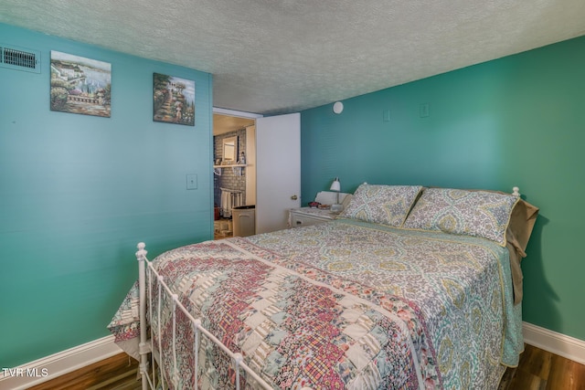 629 Buffalo Rd, Blountville, TN 37617 - bedroom with wood finished floors, baseboards, and a textured ceiling