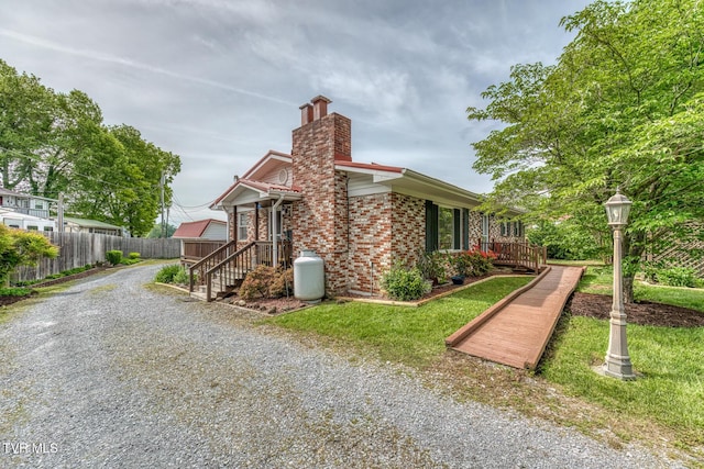 629 Buffalo Rd, Blountville, TN 37617 - view of side of home featuring a chimney, fence, driveway, and brick siding