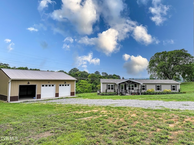 2551 Cedar Creek Rd, Russellville, TN 37860 - view of front of home featuring an outdoor structure, a detached garage, a front yard, and metal roof