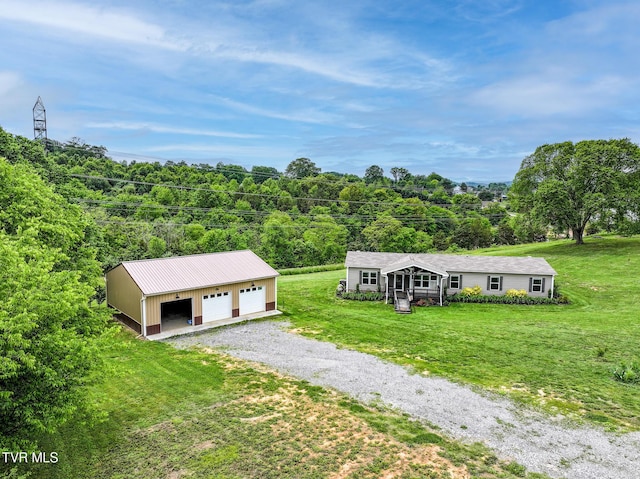 2551 Cedar Creek Rd, Russellville, TN 37860 - view of front facade with a garage, an outdoor structure, a front yard, and a forest view
