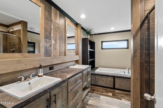2551 Cedar Creek Rd, Russellville, TN 37860 - bathroom with a stall shower, a garden tub, wood finished floors, double vanity, and ornamental molding