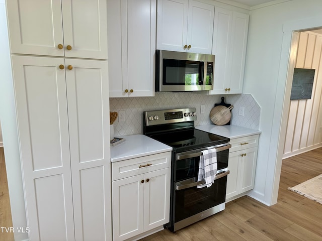 8467 Rich Valley Rd, Bristol, VA 24202 - kitchen featuring appliances with stainless steel finishes, light countertops, light wood-style flooring, and backsplash