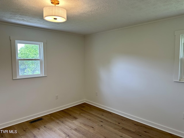 8467 Rich Valley Rd, Bristol, VA 24202 - empty room featuring hardwood / wood-style flooring, a textured ceiling, baseboards, and ornamental molding
