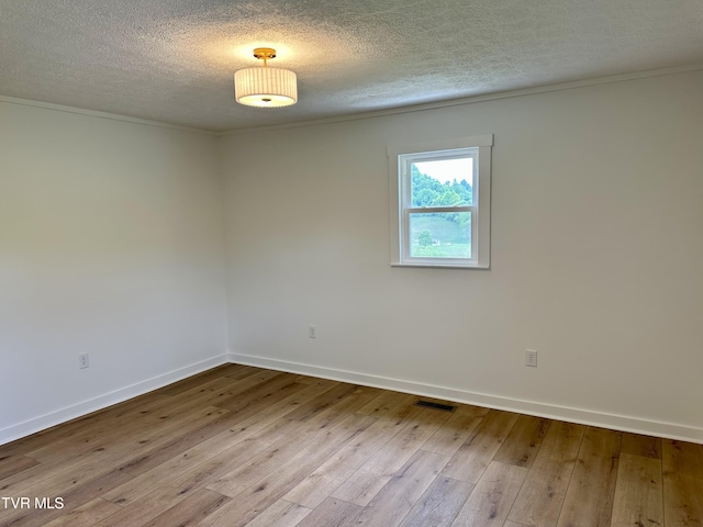 8467 Rich Valley Rd, Bristol, VA 24202 - spare room featuring a textured ceiling, hardwood / wood-style flooring, baseboards, and crown molding