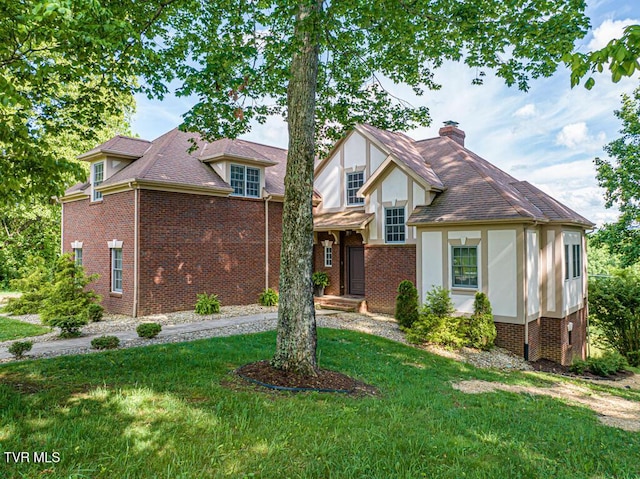 15127 Stonewall Rdg, Bristol, VA 24202 - tudor house featuring a front yard, brick siding, a chimney, and stucco siding