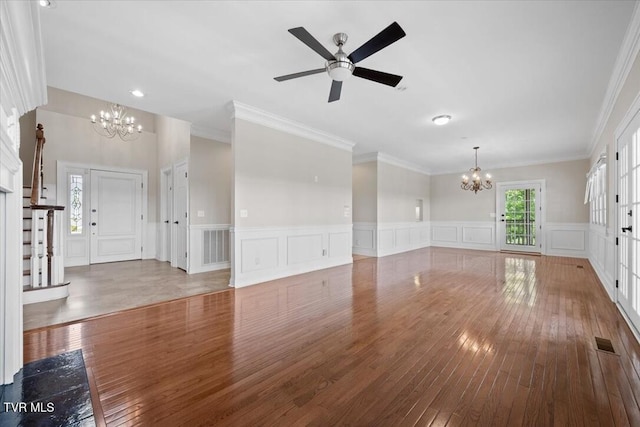 15127 Stonewall Rdg, Bristol, VA 24202 - unfurnished living room featuring a chandelier, wood-type flooring, a decorative wall, crown molding, and ceiling fan