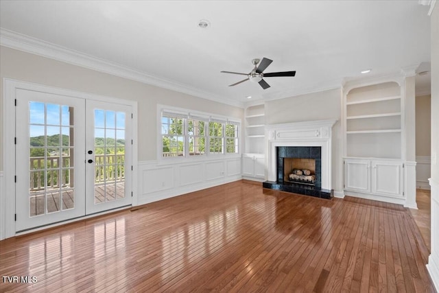 15127 Stonewall Rdg, Bristol, VA 24202 - unfurnished living room featuring hardwood / wood-style flooring, crown molding, ceiling fan, built in shelves, and a fireplace