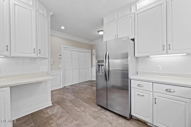 15127 Stonewall Rdg, Bristol, VA 24202 - kitchen with stainless steel refrigerator with ice dispenser, crown molding, white cabinets, light countertops, and wainscoting