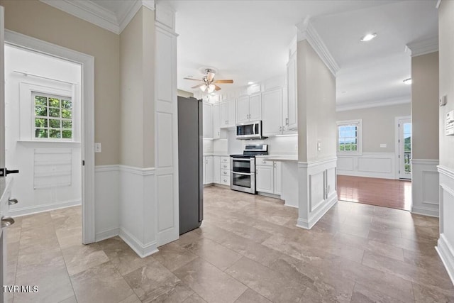 15127 Stonewall Rdg, Bristol, VA 24202 - kitchen with appliances with stainless steel finishes, white cabinetry, ornamental molding, ceiling fan, and light countertops