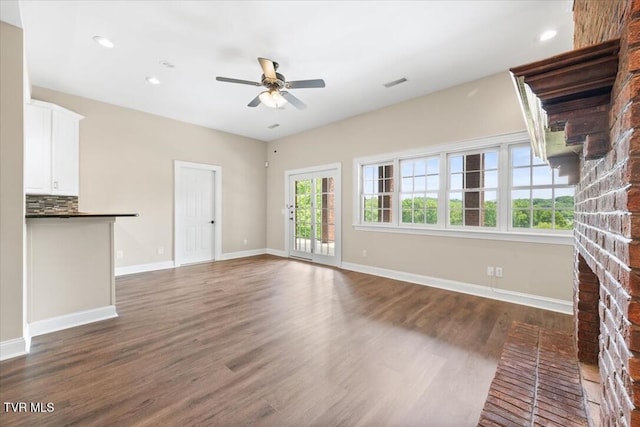 15127 Stonewall Rdg, Bristol, VA 24202 - unfurnished living room featuring a ceiling fan, wood finished floors, baseboards, recessed lighting, and a brick fireplace