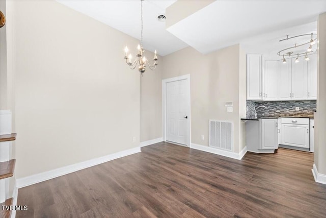 15127 Stonewall Rdg, Bristol, VA 24202 - unfurnished dining area with a chandelier, dark wood finished floors, baseboards, and a sink