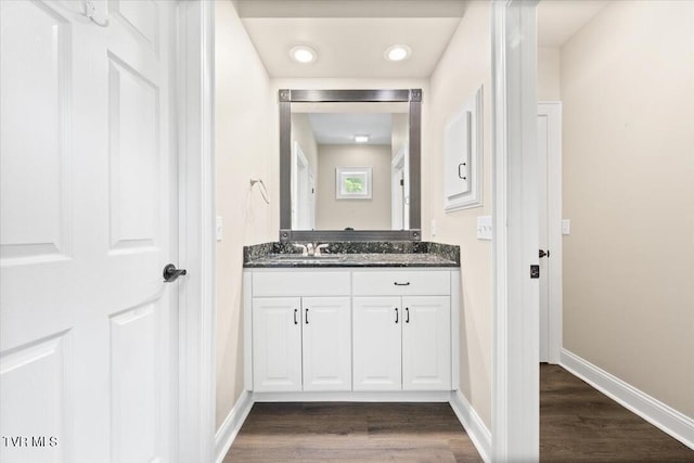 15127 Stonewall Rdg, Bristol, VA 24202 - bathroom featuring wood finished floors, double vanity, baseboards, and recessed lighting