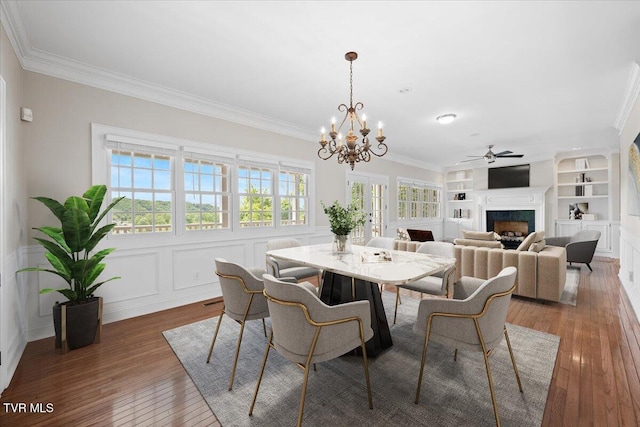 15127 Stonewall Rdg, Bristol, VA 24202 - dining area with crown molding, hardwood / wood-style flooring, a fireplace, built in shelves, and a chandelier