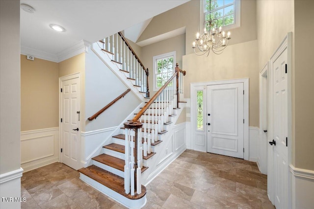 15127 Stonewall Rdg, Bristol, VA 24202 - foyer with stairs, a decorative wall, wainscoting, a chandelier, and crown molding