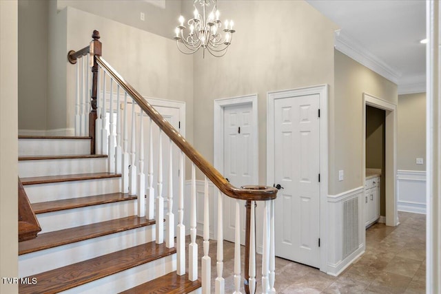 15127 Stonewall Rdg, Bristol, VA 24202 - stairs with a wainscoted wall, a decorative wall, crown molding, and a chandelier