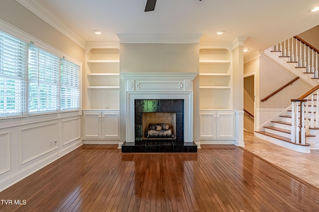15127 Stonewall Rdg, Bristol, VA 24202 - unfurnished living room featuring hardwood / wood-style floors, built in features, stairs, crown molding, and a decorative wall