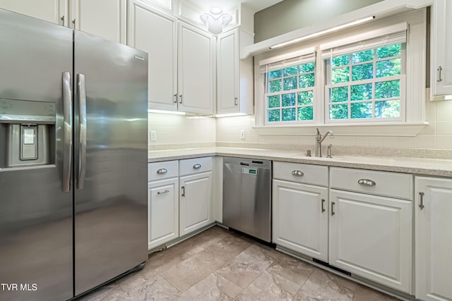 15127 Stonewall Rdg, Bristol, VA 24202 - kitchen with appliances with stainless steel finishes, tasteful backsplash, white cabinets, and light stone finish floors