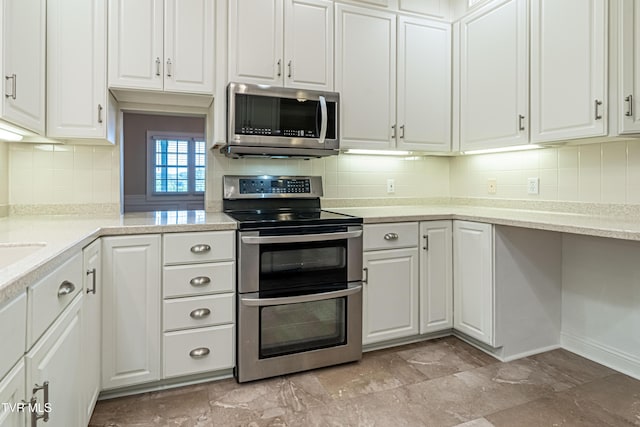 15127 Stonewall Rdg, Bristol, VA 24202 - kitchen with appliances with stainless steel finishes, white cabinetry, light countertops, and tasteful backsplash
