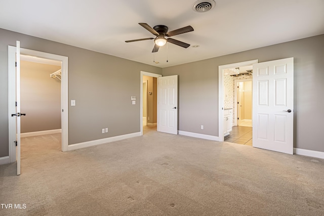 15127 Stonewall Rdg, Bristol, VA 24202 - unfurnished bedroom featuring light carpet, a spacious closet, ensuite bath, ceiling fan, and a closet