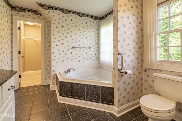 15127 Stonewall Rdg, Bristol, VA 24202 - bathroom featuring a garden tub, vanity, wallpapered walls, tile patterned floors, and a walk in closet