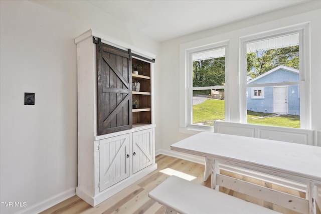 2504 Fort Henry Dr, Kingsport, TN 37664 - dining area with light wood-type flooring, healthy amount of natural light, and a barn door