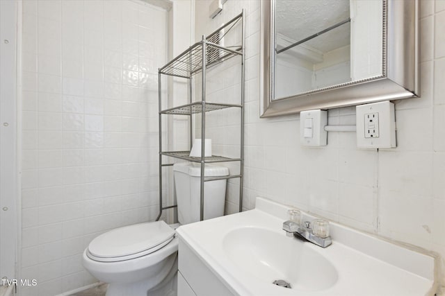 2504 Fort Henry Dr, Kingsport, TN 37664 - half bath featuring tile walls, toilet, a textured ceiling, and vanity
