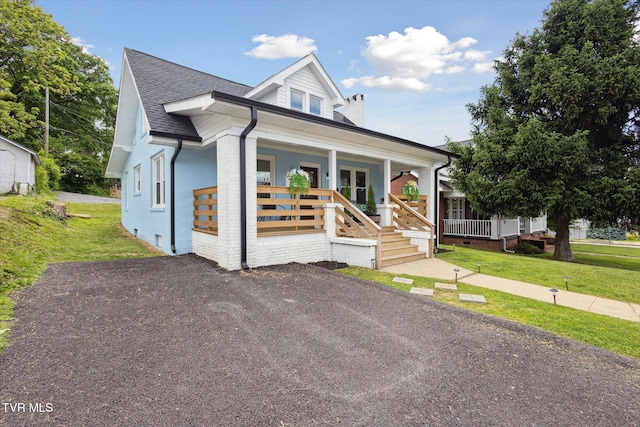 2504 Fort Henry Dr, Kingsport, TN 37664 - view of front of property featuring covered porch, a front lawn, a chimney, and brick siding