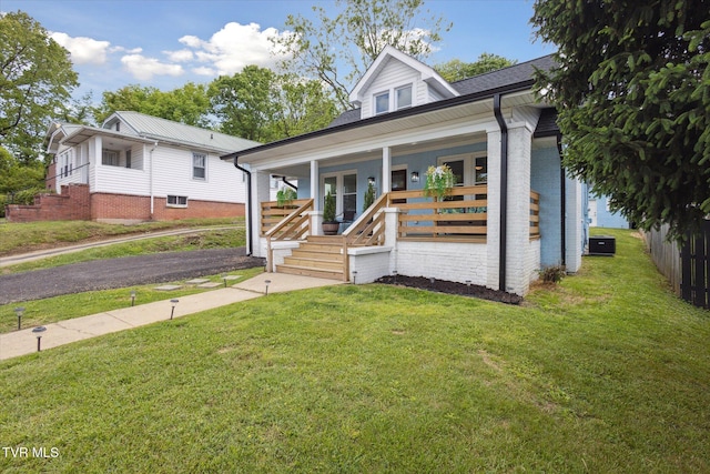 2504 Fort Henry Dr, Kingsport, TN 37664 - view of front of home featuring covered porch, a front lawn, brick siding, and central air condition unit