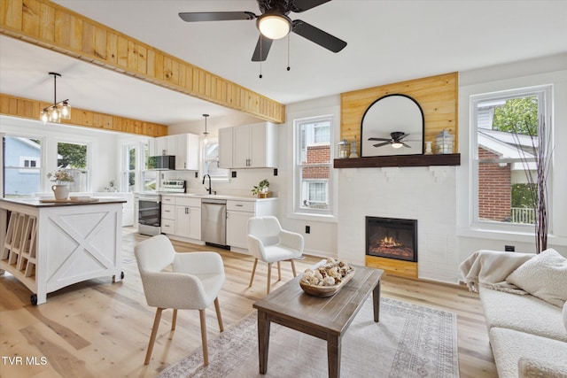 2504 Fort Henry Dr, Kingsport, TN 37664 - living room featuring a ceiling fan, light wood-style flooring, healthy amount of natural light, and a large fireplace