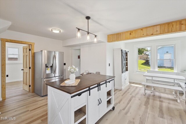 2504 Fort Henry Dr, Kingsport, TN 37664 - kitchen with stainless steel refrigerator with ice dispenser, light wood finished floors, white cabinetry, butcher block counters, and open shelves