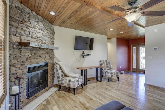 138 Ray Cemetery Rd, Roan Mountain, TN 37687 - living area with a fireplace, baseboards, wood finished floors, wood ceiling, and ceiling fan