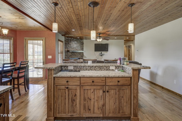 138 Ray Cemetery Rd, Roan Mountain, TN 37687 - kitchen featuring wooden ceiling, ceiling fan, light wood finished floors, brown cabinetry, and pendant lighting