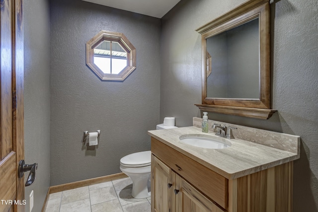 138 Ray Cemetery Rd, Roan Mountain, TN 37687 - bathroom featuring toilet, vanity, baseboards, a textured wall, and tile patterned flooring
