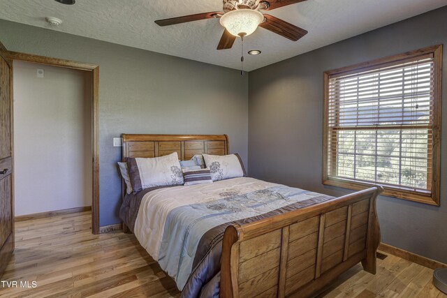 138 Ray Cemetery Rd, Roan Mountain, TN 37687 - bedroom featuring light wood finished floors, baseboards, and a ceiling fan