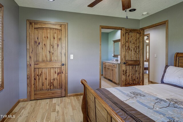 138 Ray Cemetery Rd, Roan Mountain, TN 37687 - bedroom featuring light wood-style flooring, baseboards, a textured ceiling, and ceiling fan