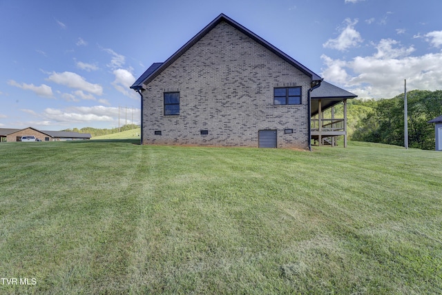 138 Ray Cemetery Rd, Roan Mountain, TN 37687 - view of home's exterior with crawl space, a yard, and brick siding