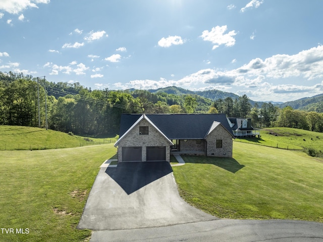 138 Ray Cemetery Rd, Roan Mountain, TN 37687 - view of front of property featuring driveway, a front lawn, a mountain view, and brick siding