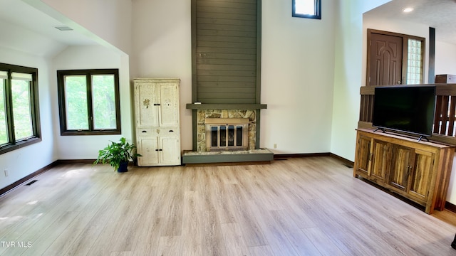 15 Crown Cir Unit 15, Kingsport, TN 37660 - unfurnished living room with baseboards, wood finished floors, vaulted ceiling, and a stone fireplace