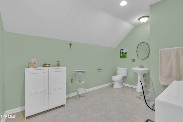 1905 Martin Rd, Limestone, TN 37681 - bathroom featuring vaulted ceiling, toilet, baseboards, and a sink