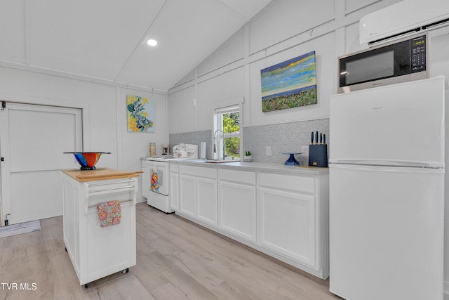 1905 Martin Rd, Limestone, TN 37681 - kitchen with white appliances, vaulted ceiling, a sink, tasteful backsplash, and white cabinets
