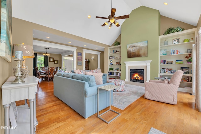 1905 Martin Rd, Limestone, TN 37681 - living area featuring a glass covered fireplace, light wood finished floors, a ceiling fan, high vaulted ceiling, and built in features