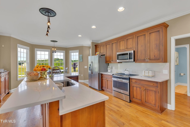 1905 Martin Rd, Limestone, TN 37681 - kitchen with appliances with stainless steel finishes, a sink, brown cabinetry, baseboards, and crown molding